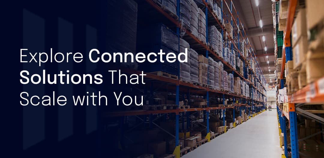 Warehouse with shelves full of products and the text 'Explore Connected Solutions That Scale with You' overlaying the image.