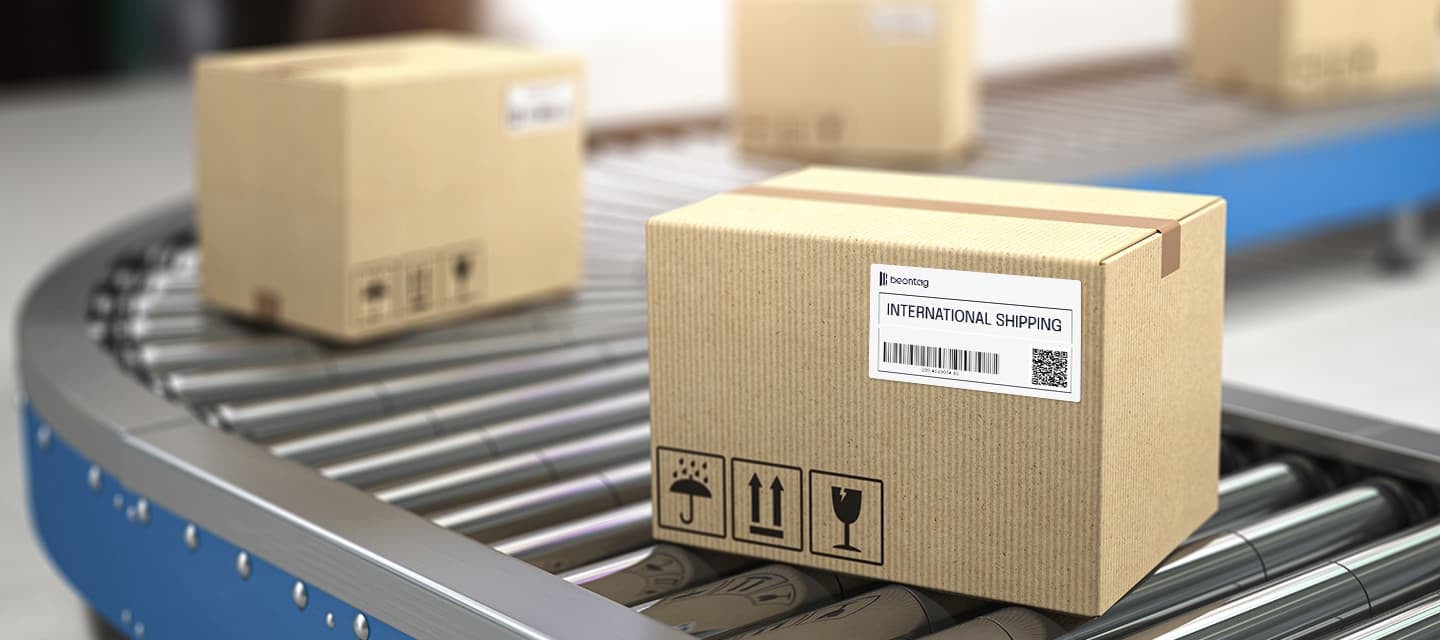 Cardboard boxes moving along a conveyor belt with shipping labels attached, illustrating the role of Pressure-Sensitive Adhesives in Supply Chain labeling for reliable package identification and logistics tracking.