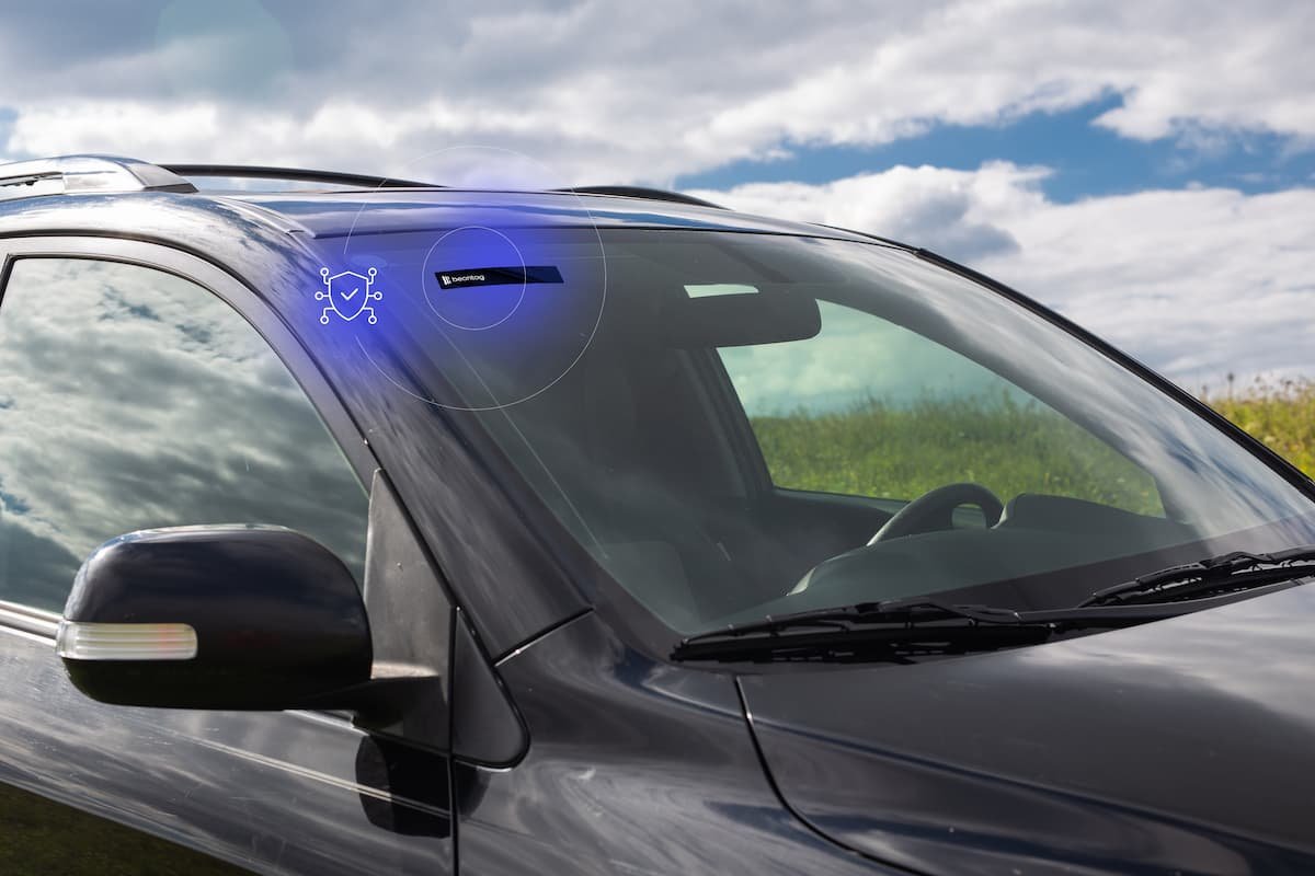 Car windshield with an RFID tag near the A-pillar, illustrating rfid read range for vehicle identification and access control.